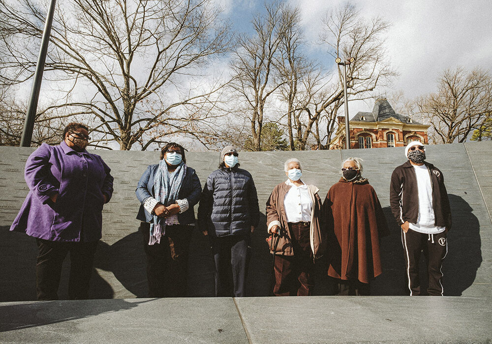 Descendants of enslaved laborers stand in front of UVA's Memorial to Enslaved Laborers