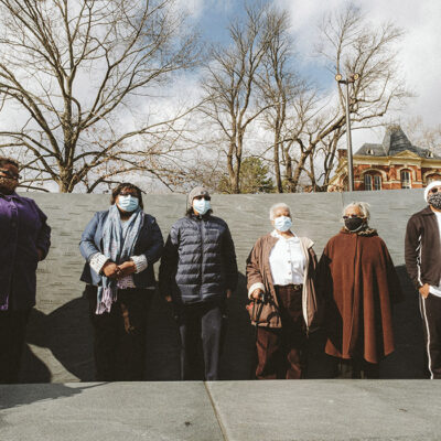 Descendants of enslaved laborers stand in front of UVA's Memorial to Enslaved Laborers