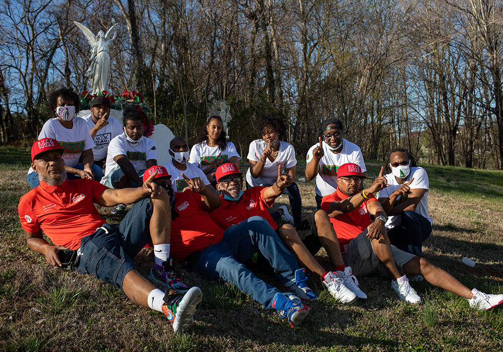 B.U.C.K. Squad members smiling siting on the grass