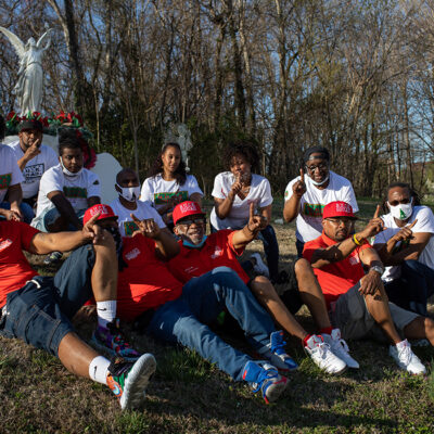 B.U.C.K. Squad members smiling siting on the grass