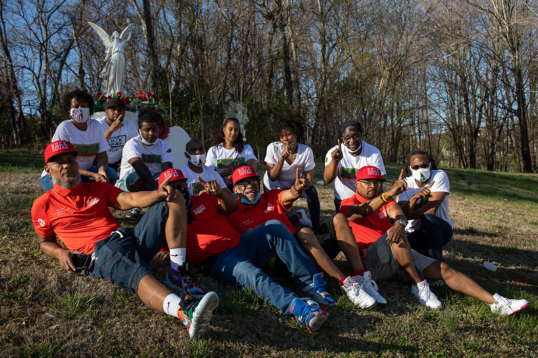 B.U.C.K. Squad members smiling siting on the grass