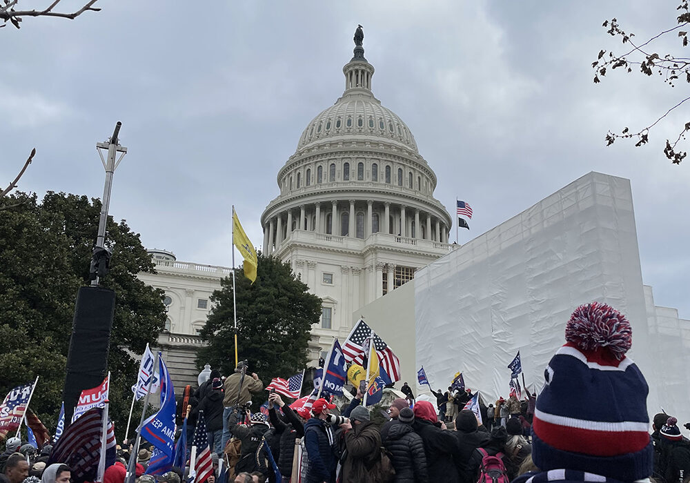 Capitol rioters hold Trump flags near Capitol building