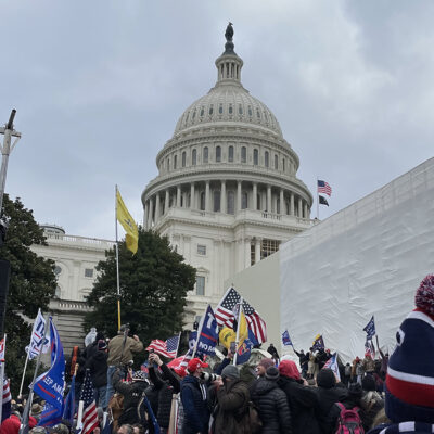 Capitol rioters hold Trump flags near Capitol building