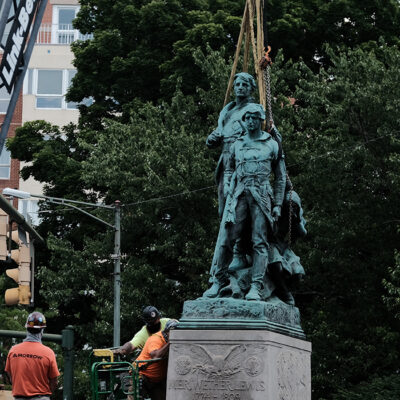 Lewis Clark and Sacajawea statue about to be lifted in the air by a crane