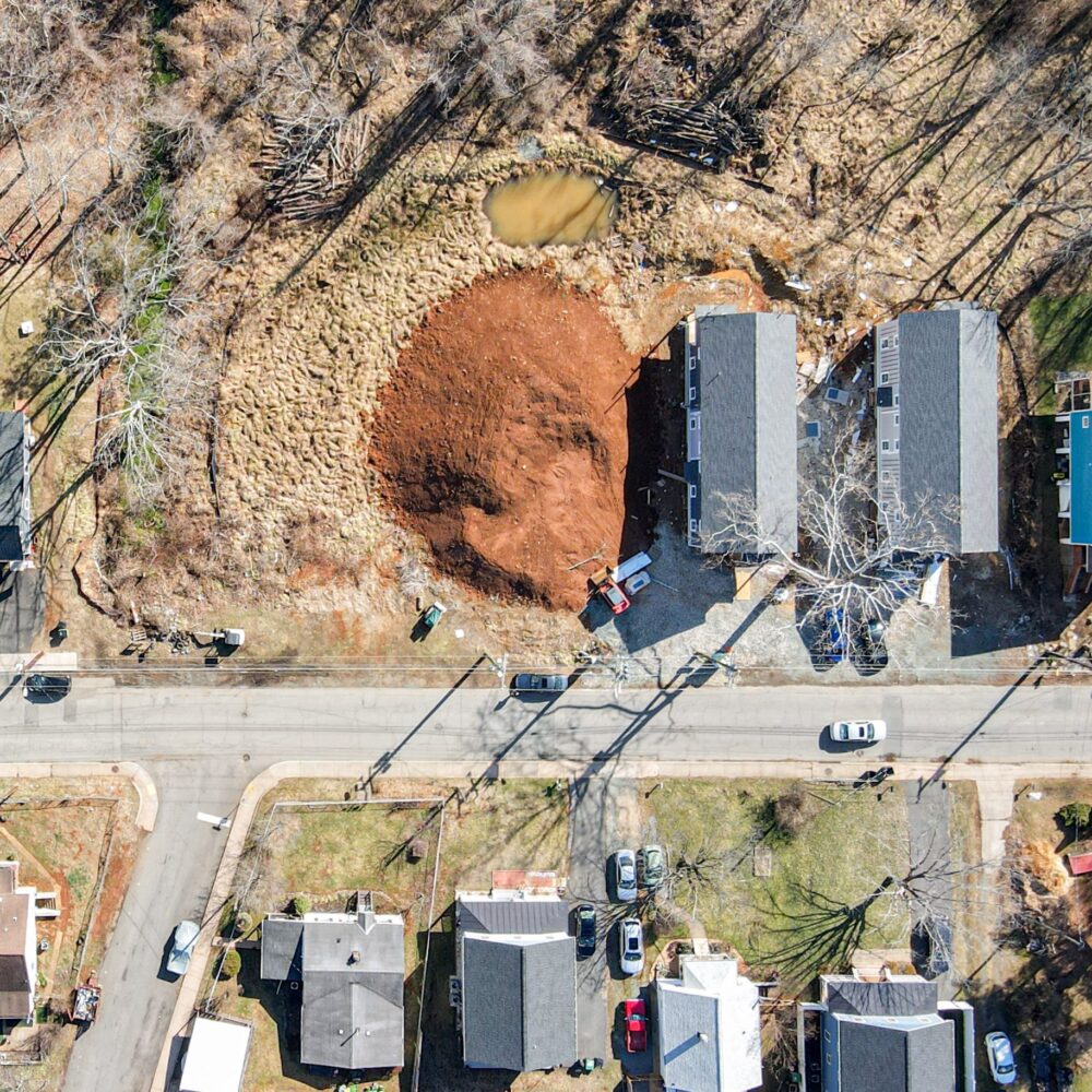 aerial photo of several homes and an empty lot