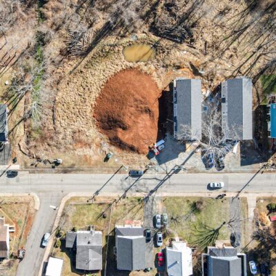 aerial photo of several homes and an empty lot