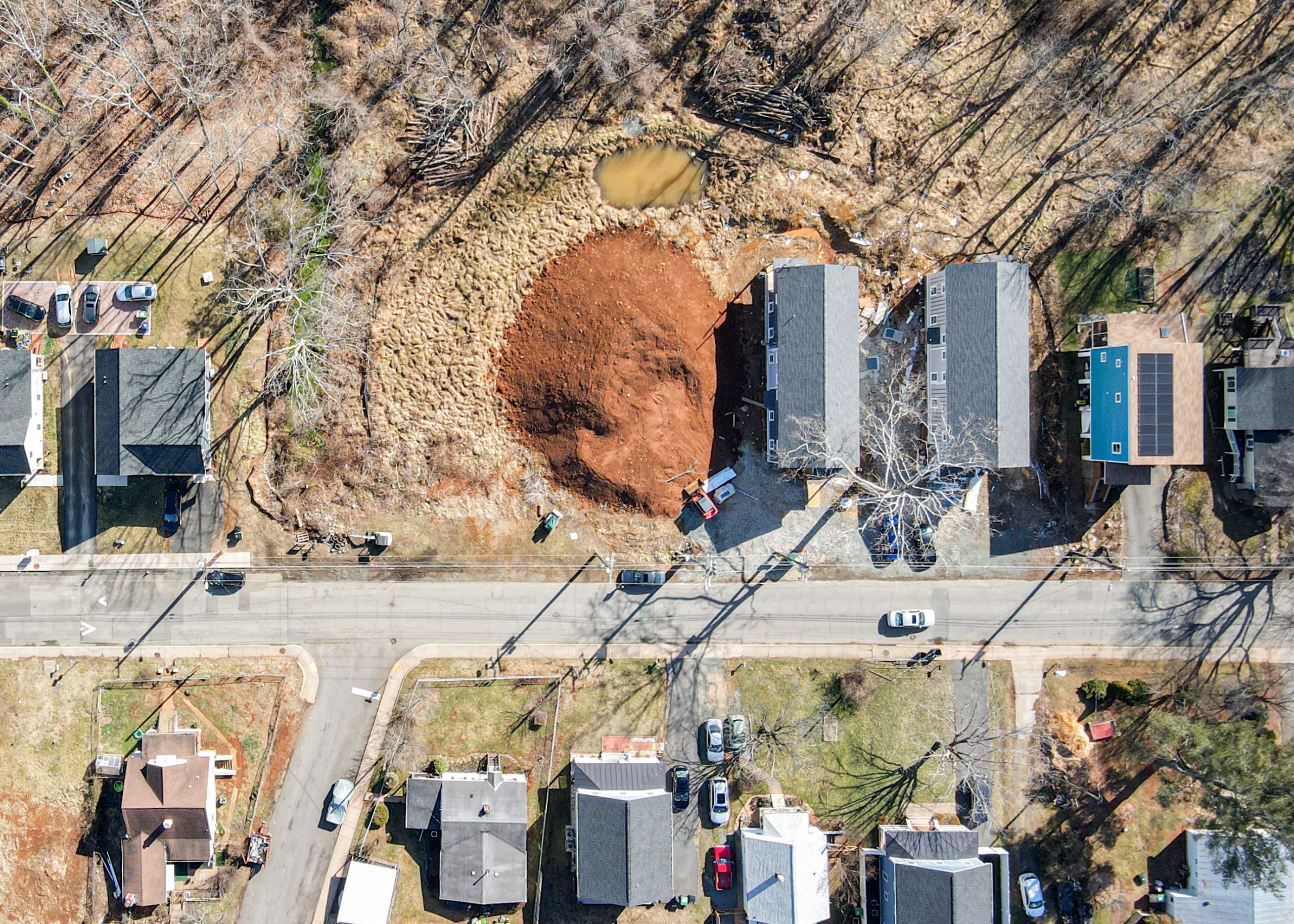 aerial photo of several homes and an empty lot